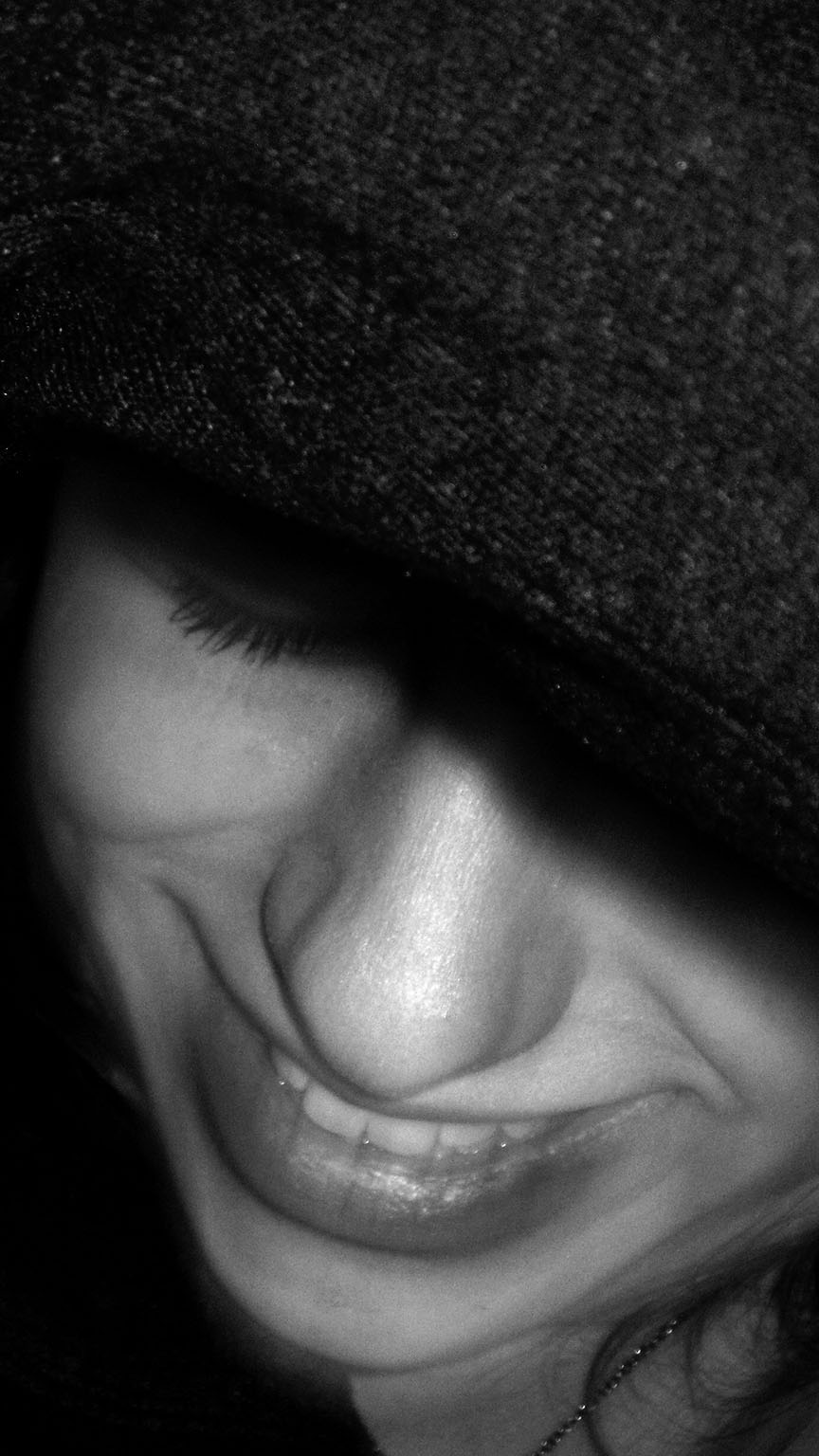 A girl wearing a gray hat in black and white